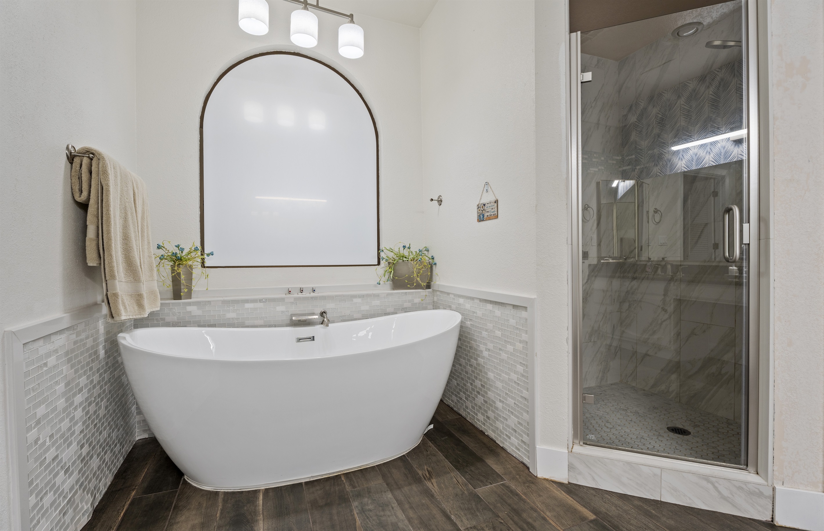 Pamper yourself in this spa-inspired bathroom with a freestanding tub, double sinks, and soothing neutral finishes.