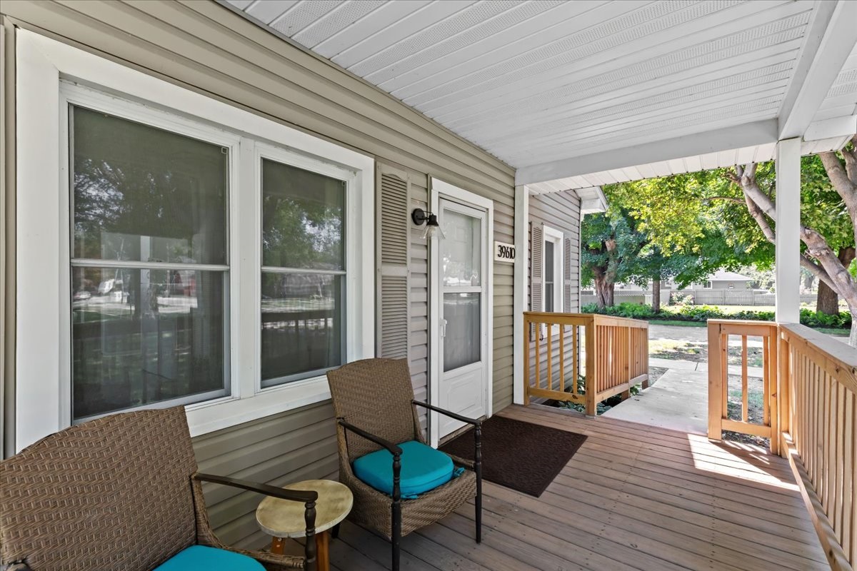 Covered porch with comfortable seating to unwind