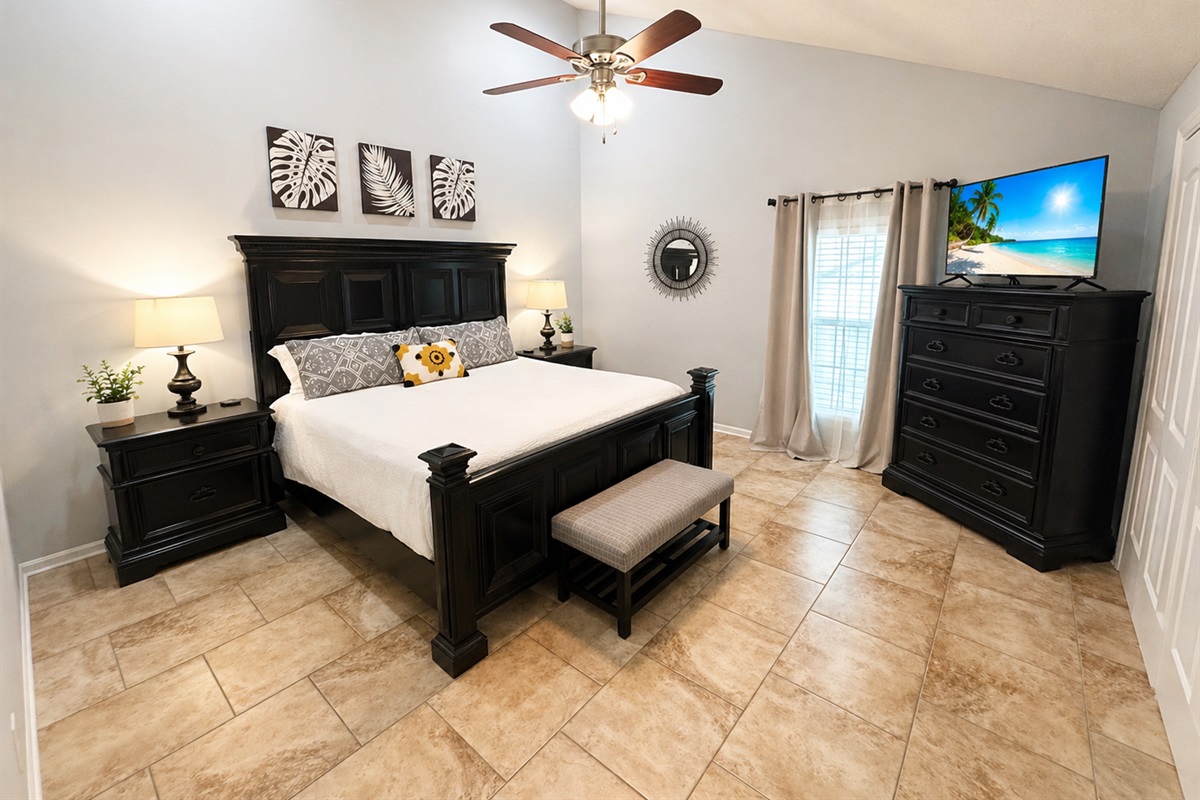 Master bedroom with king bed and vaulted ceilings