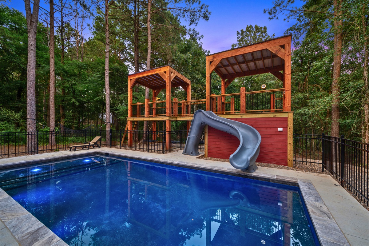 Get ready for poolside lounging and sliding fun in this modern pool with sleek concrete edges and a built-in slide, more pictures to come!