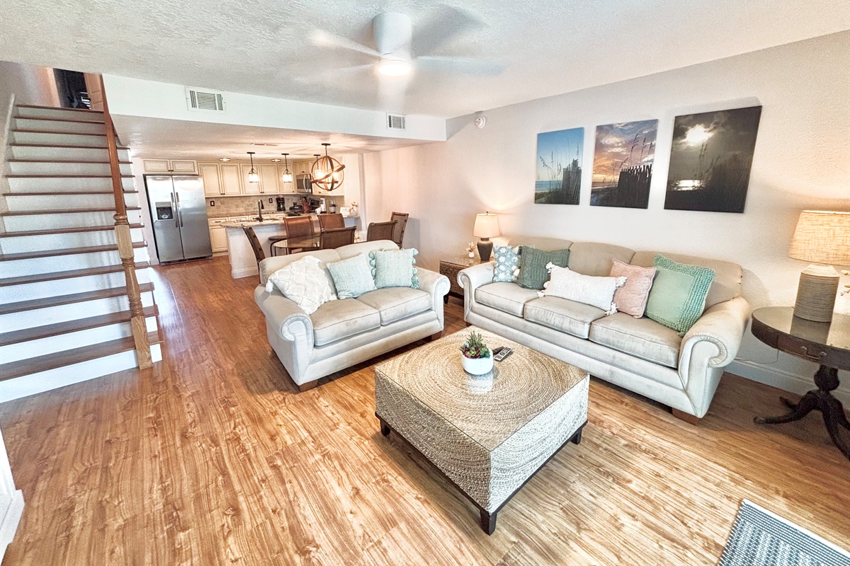 Living room with sleeper sofa and access to upstairs