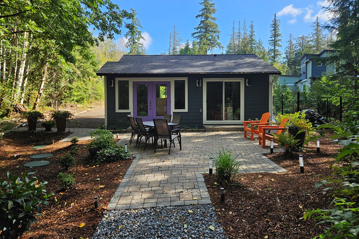650 sq ft patio with Adirondack chairs, dining table for 6, and stainless steel commercial infrared grill for summer cookouts.