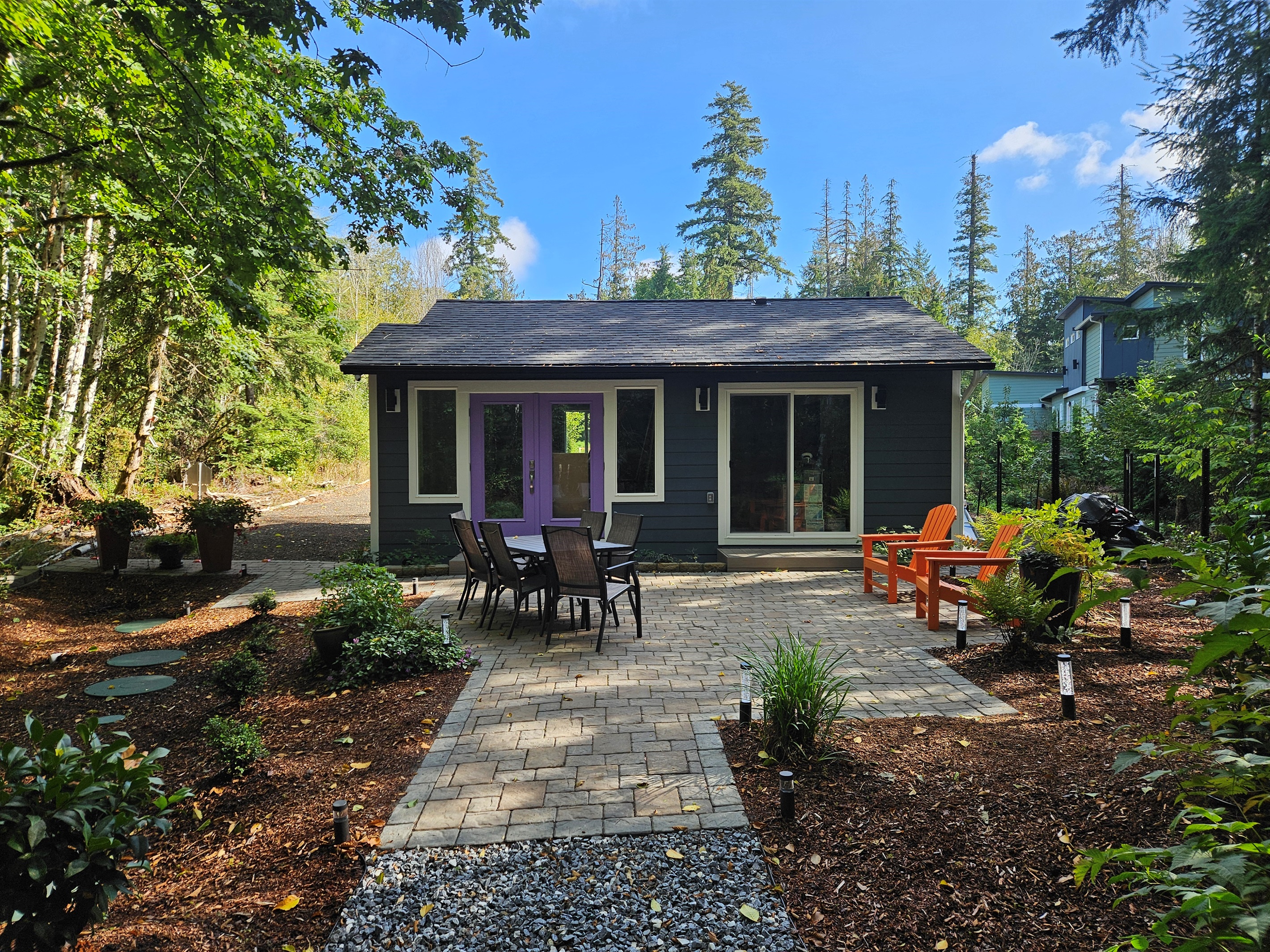 650 sq ft patio with Adirondack chairs, dining table for 6, and stainless steel commercial infrared grill for summer cookouts.