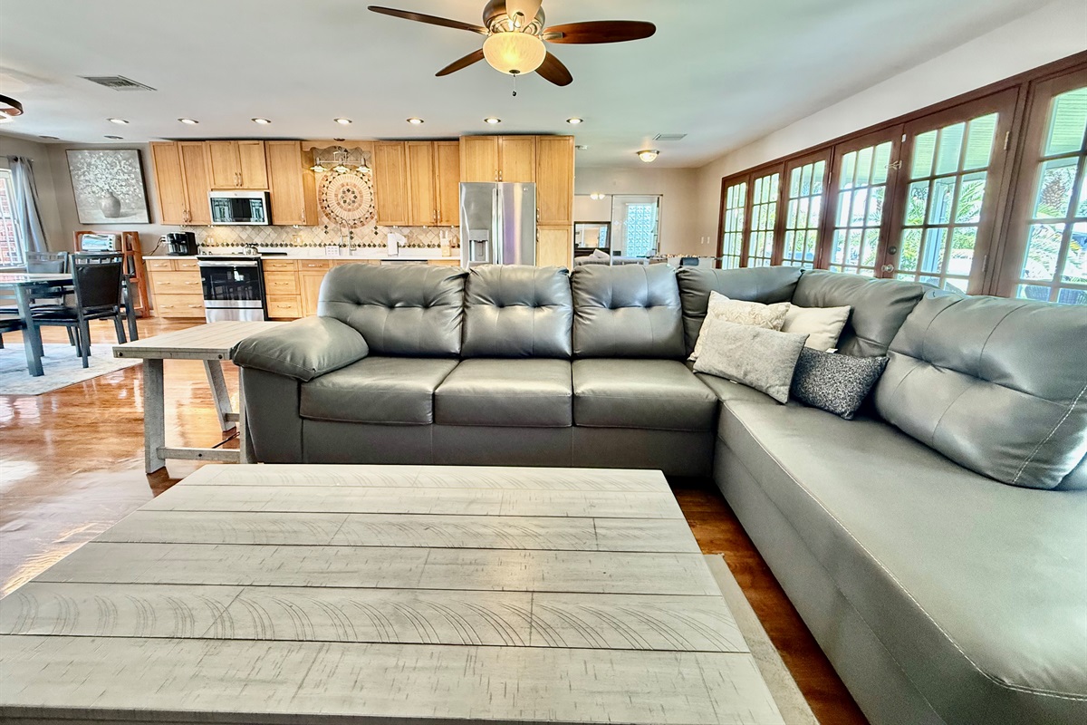 Clean lines, coastal-inspired furnishings, and floor-to-ceiling French doors make this living space the ideal mix of comfort and sophistication.