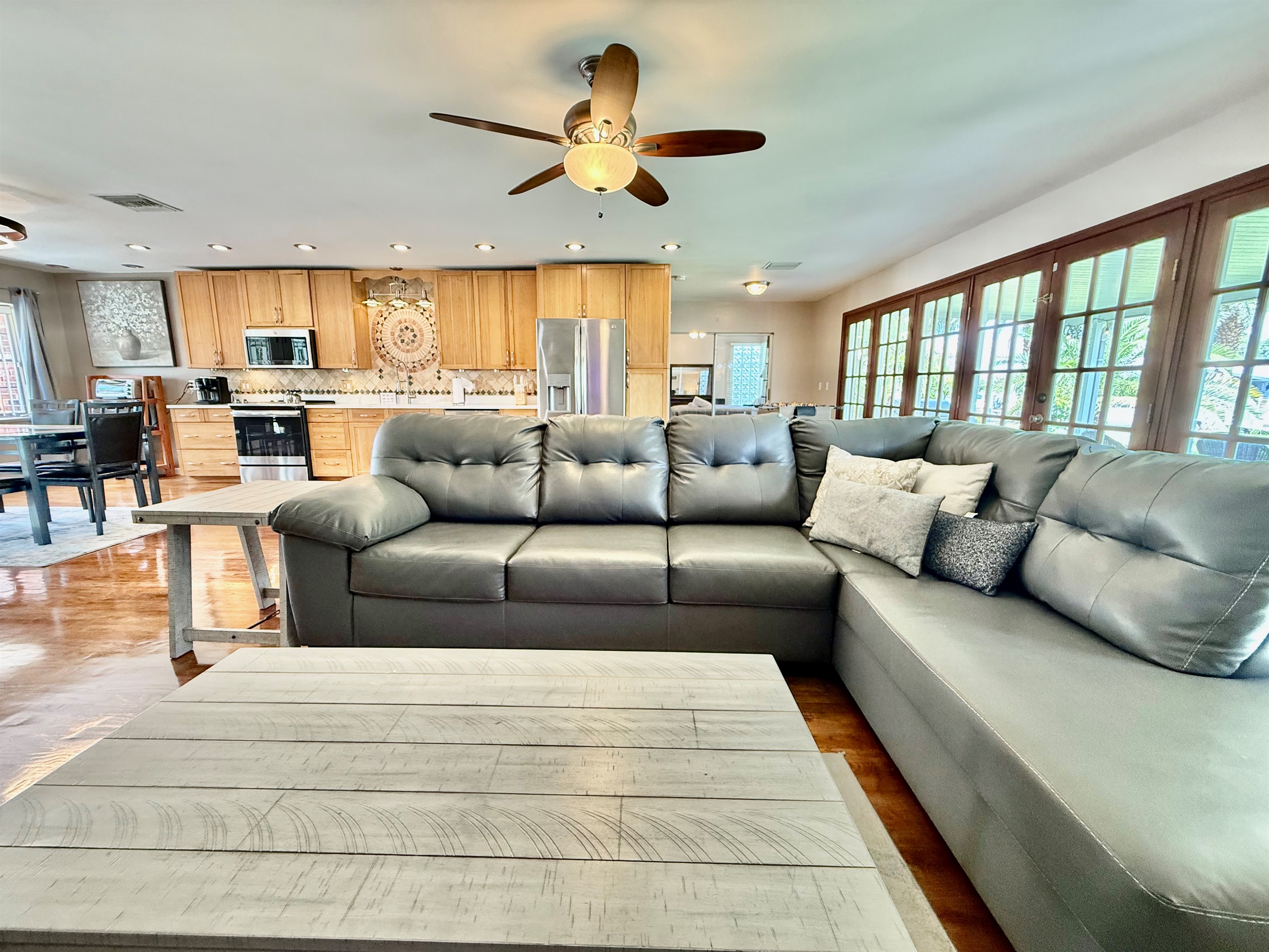 Clean lines, coastal-inspired furnishings, and floor-to-ceiling French doors make this living space the ideal mix of comfort and sophistication.