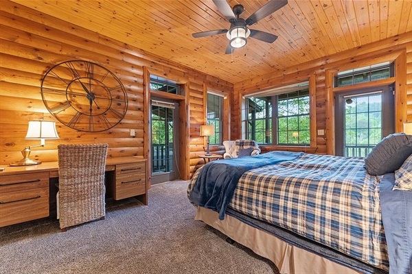 Main level king bedroom incudes desk, cozy reading corner, and walk in closet