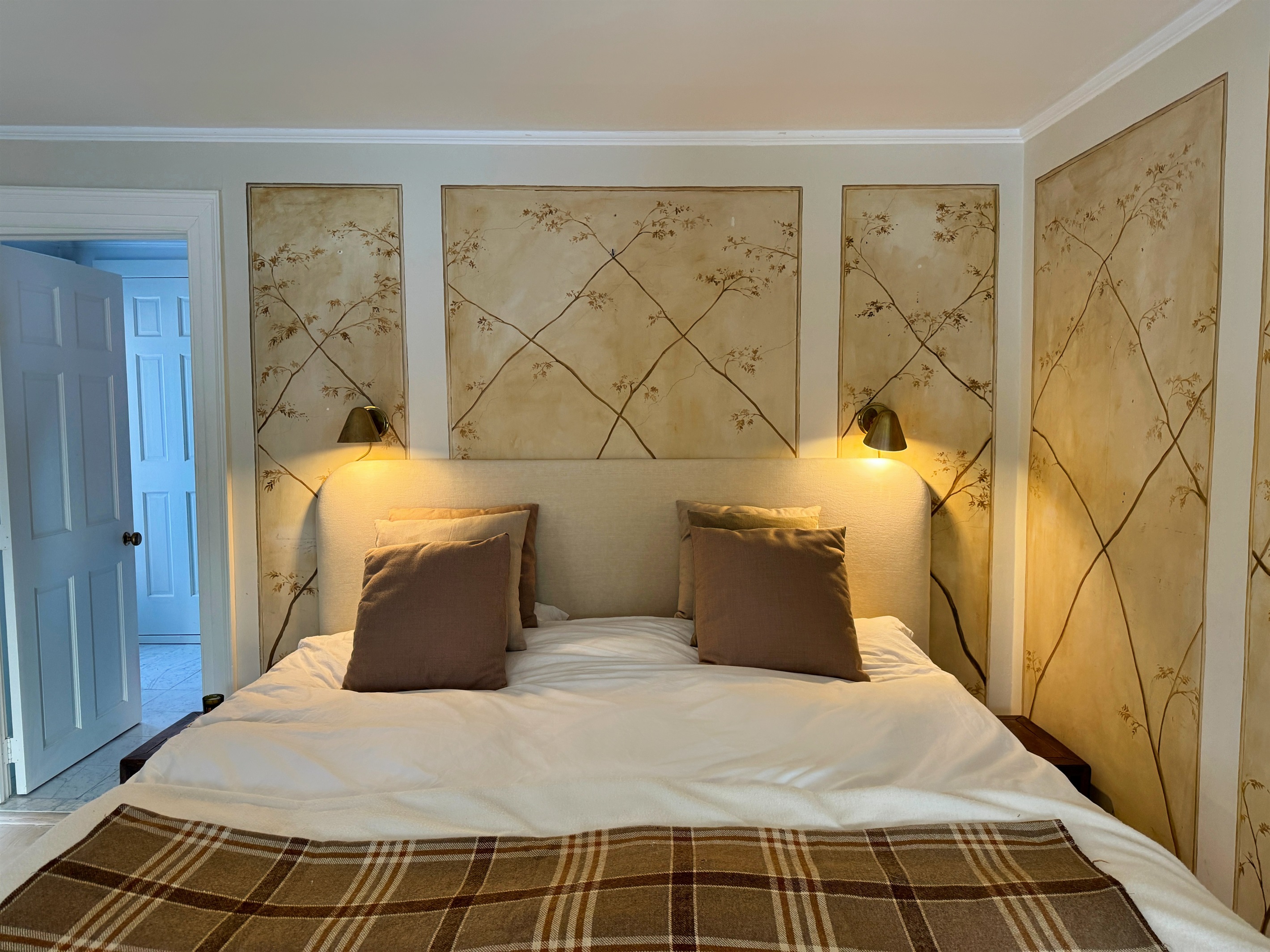 Hawk Field House - 2nd floor primary bedroom with custom hand painting on the walls.