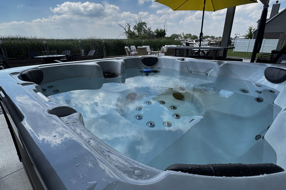 Unwind in this private outdoor hot tub set on a beautiful waterfront patio. Enjoy warm, bubbling water while taking in open sky views, fresh air, and peaceful canal-side surroundings—perfect for relaxing evenings after a day of exploring.