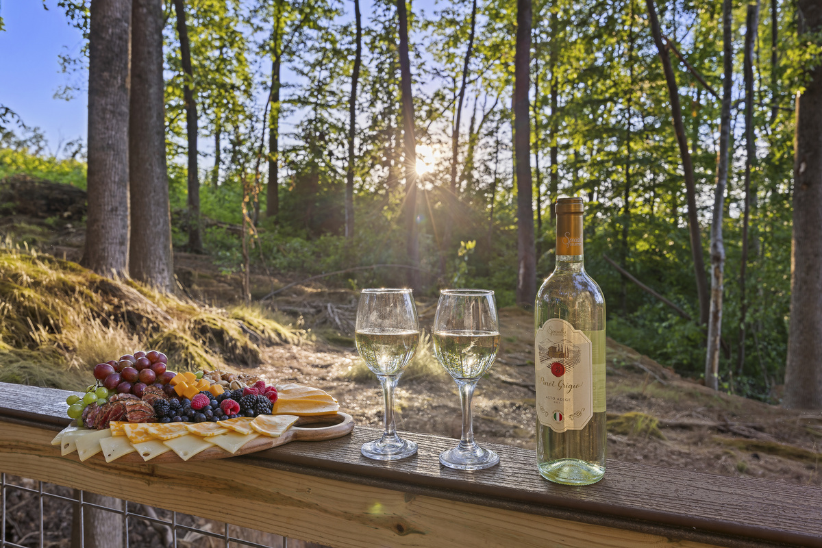 Deck Oasis: Unwind with wine and cheese while soaking in serene forest views at sunset!