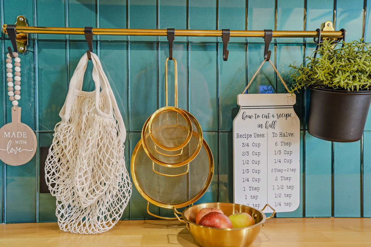 Kitchen pegboard wall with hanging organizers, produce bowl, and curated accessories