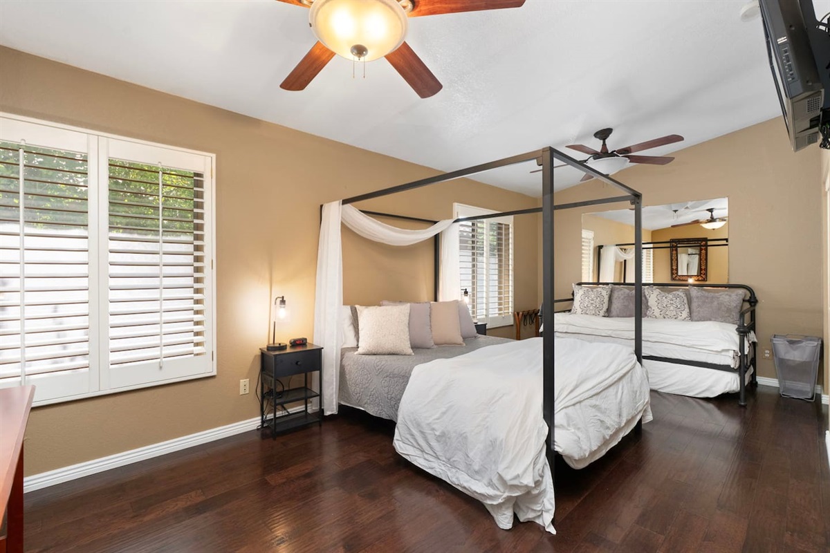 Bedroom 2 has everyone covered — a beautiful four-poster canopy queen bed and a cozy twin daybed mean the whole crew sleeps comfortably, with plenty of space to spread out and feel right at home.