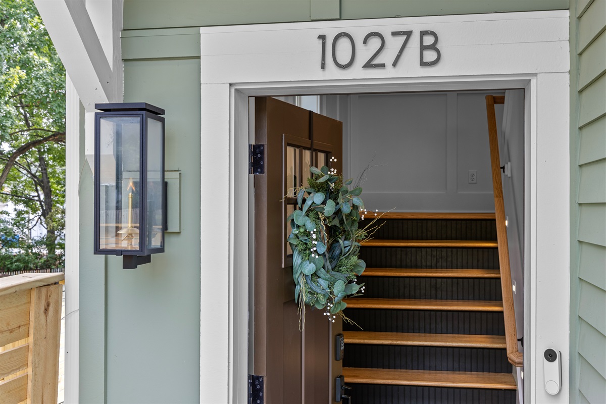 Welcoming entry with a glowing gas lantern and secure digital keypad for easy, keyless check-in.