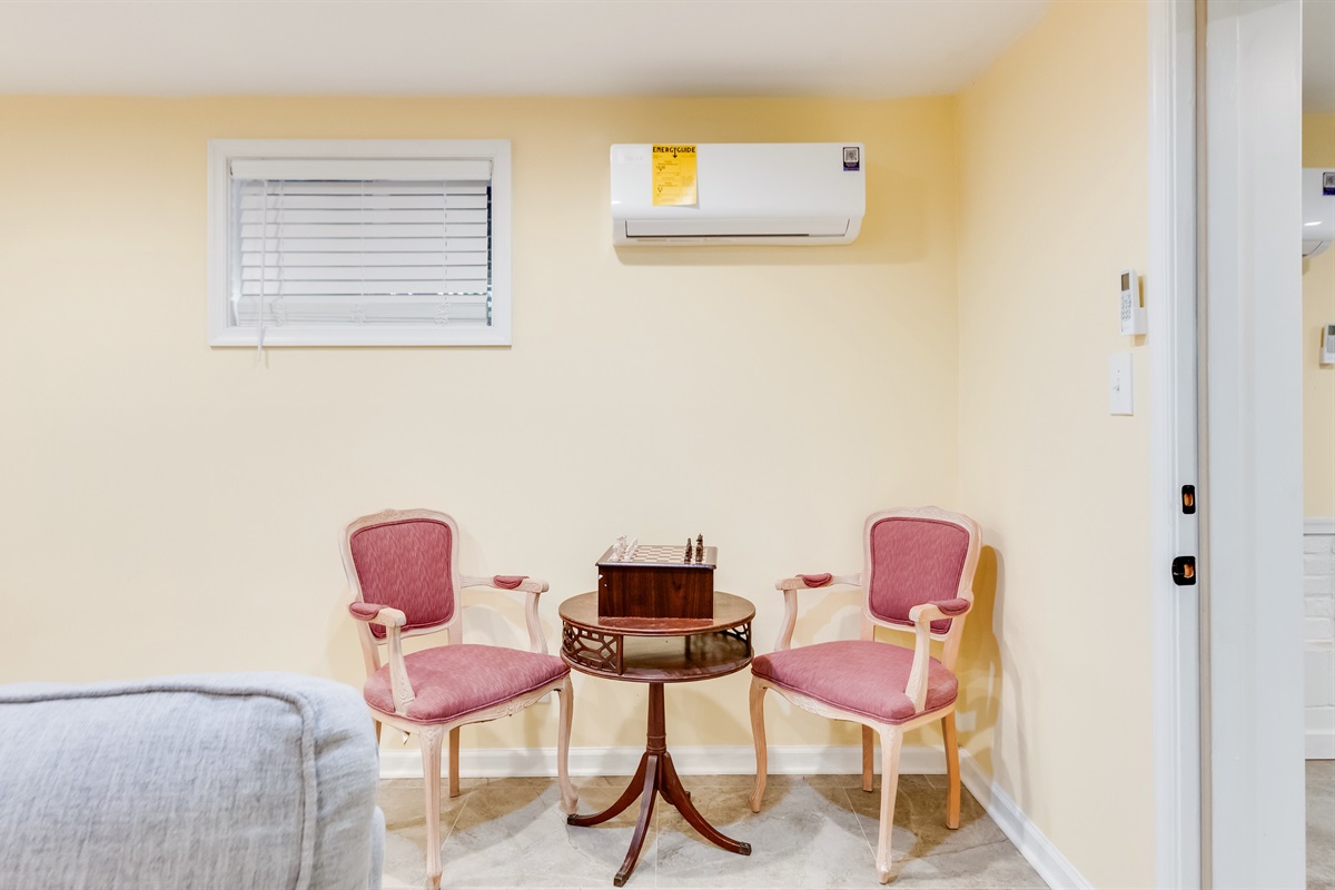 Downstairs Reading Nook: Enjoy a game of chess in this quaint corner adorned with charming pink armchairs!