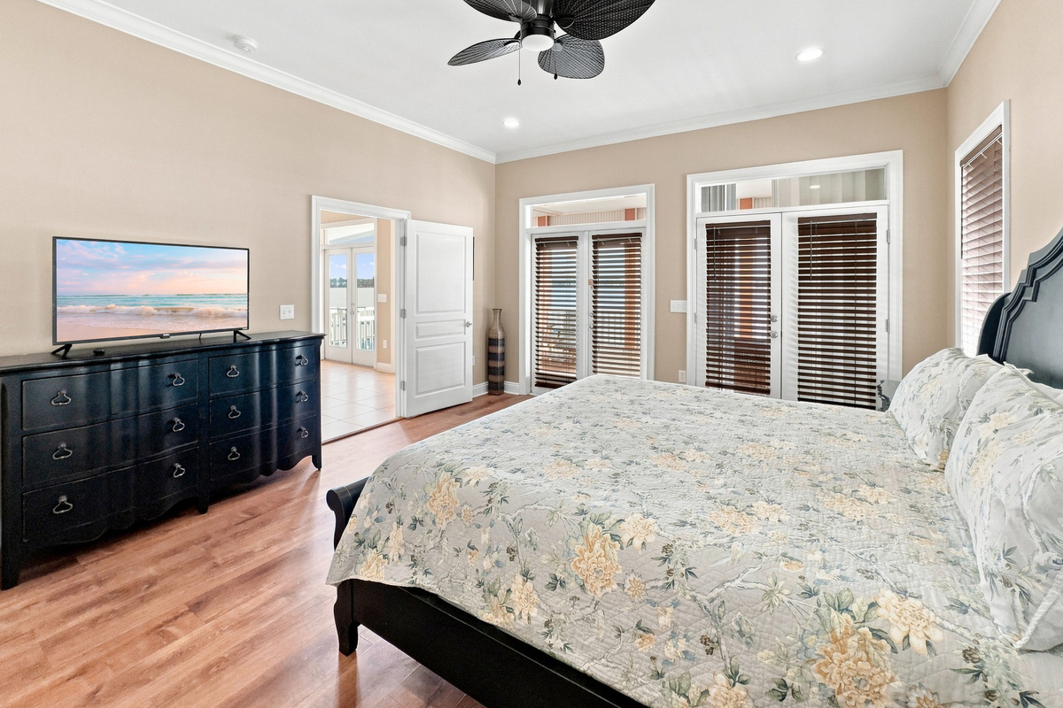 Bedroom with plantation shutters and lagoon views