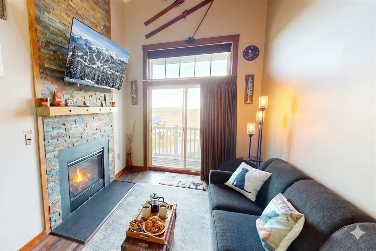 Cozy mountain living with stone fireplace & smart TV — perfect after a day on the slopes!
