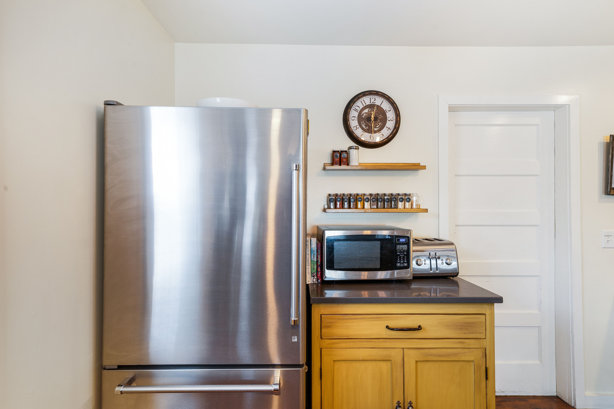 The kitchen door leads to the washroom and exits into the backyard. 