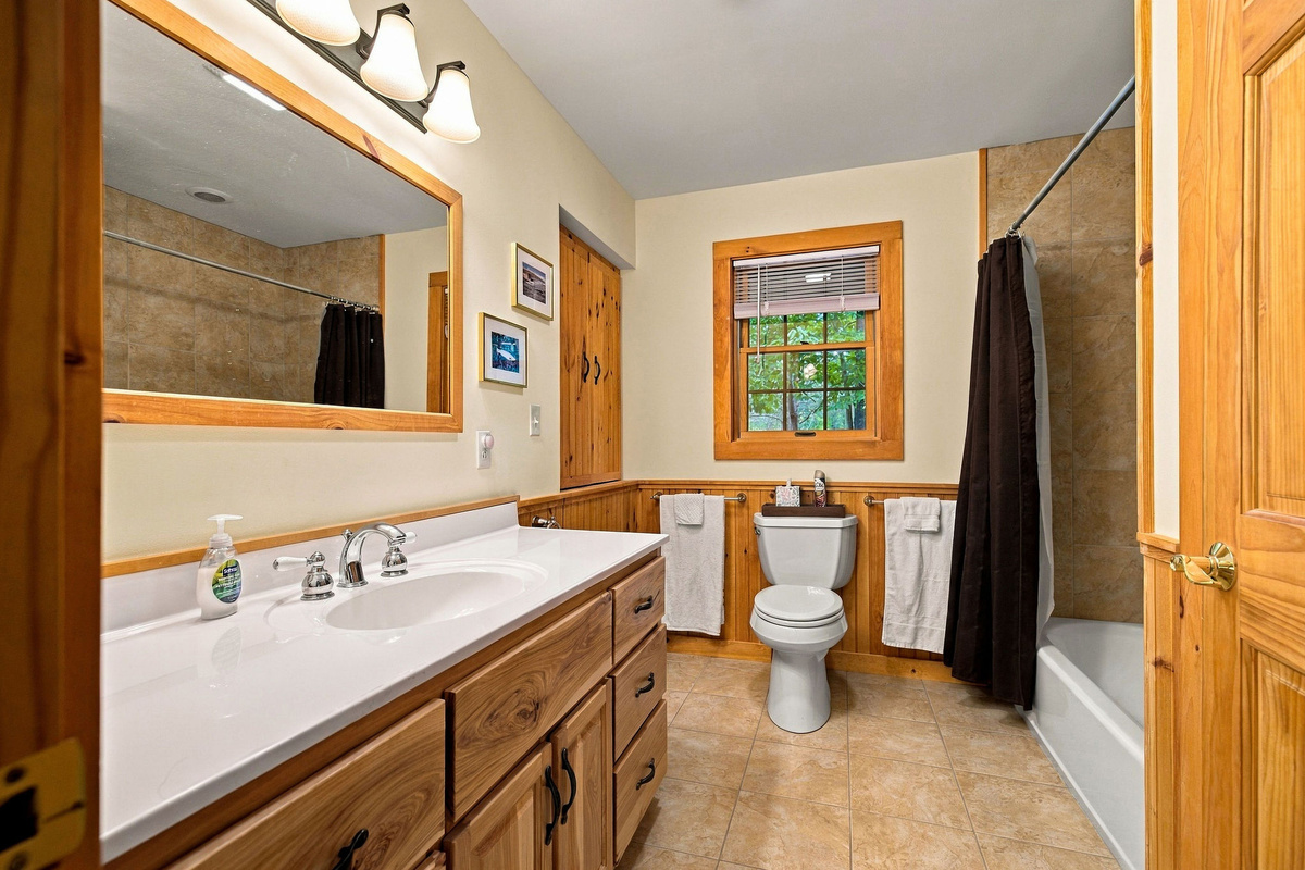 The primary bathroom features a large vanity with a sink and plenty of counter space to store your personal items.