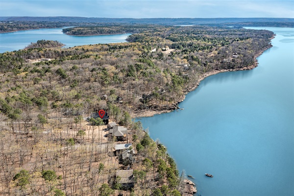 Tucked into the trees and just steps from the lake, Sunset Cove Getaway offers a private escape with unbeatable Greers Ferry views