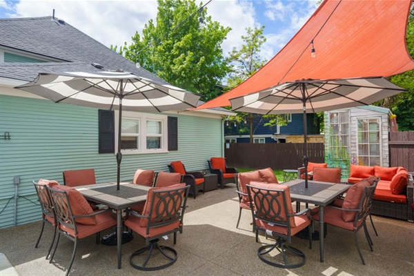 Spacious back patio dine and relax area. Plenty of comfortable seating for everyone, complete with outdoor sofas and easy access to all backyard amenities.