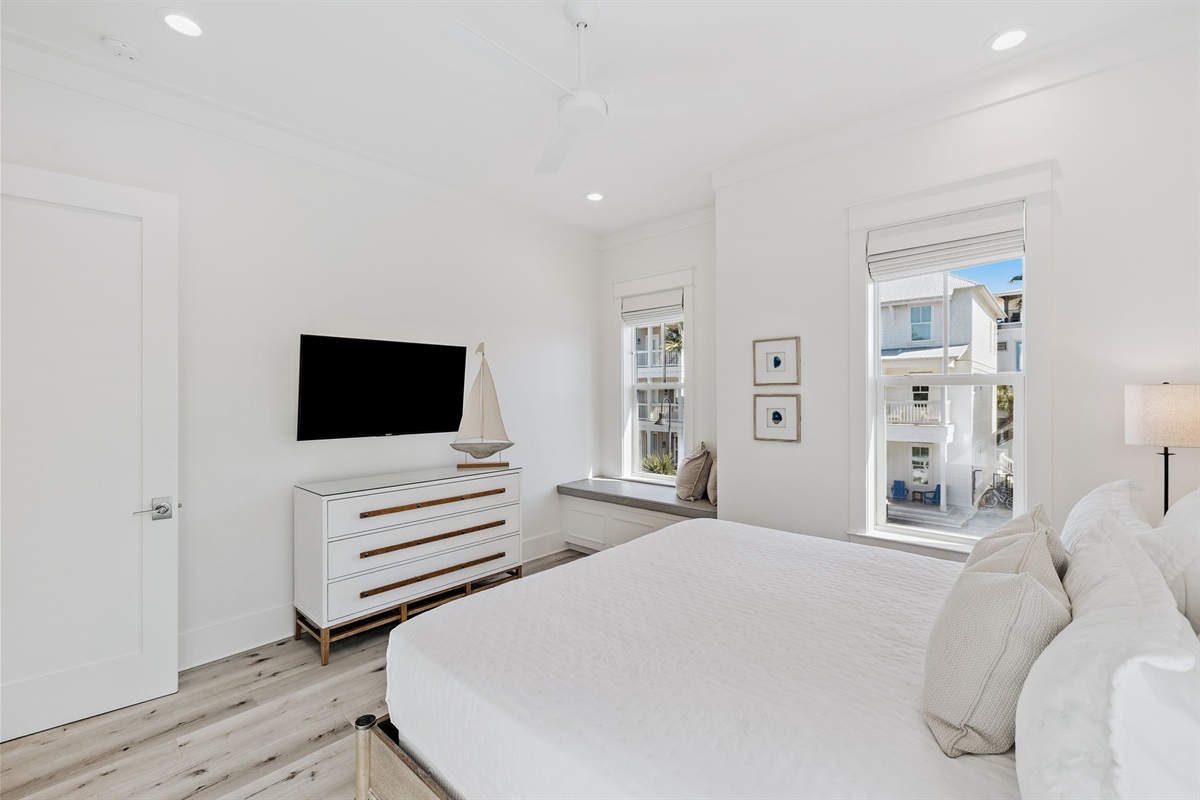 Second floor bedroom featuring a large king size bed, closet, and smart-TV.