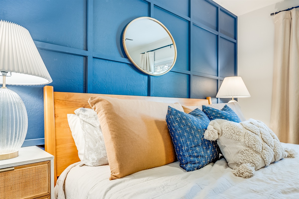 A bold blue accent wall adds a splash of personality.