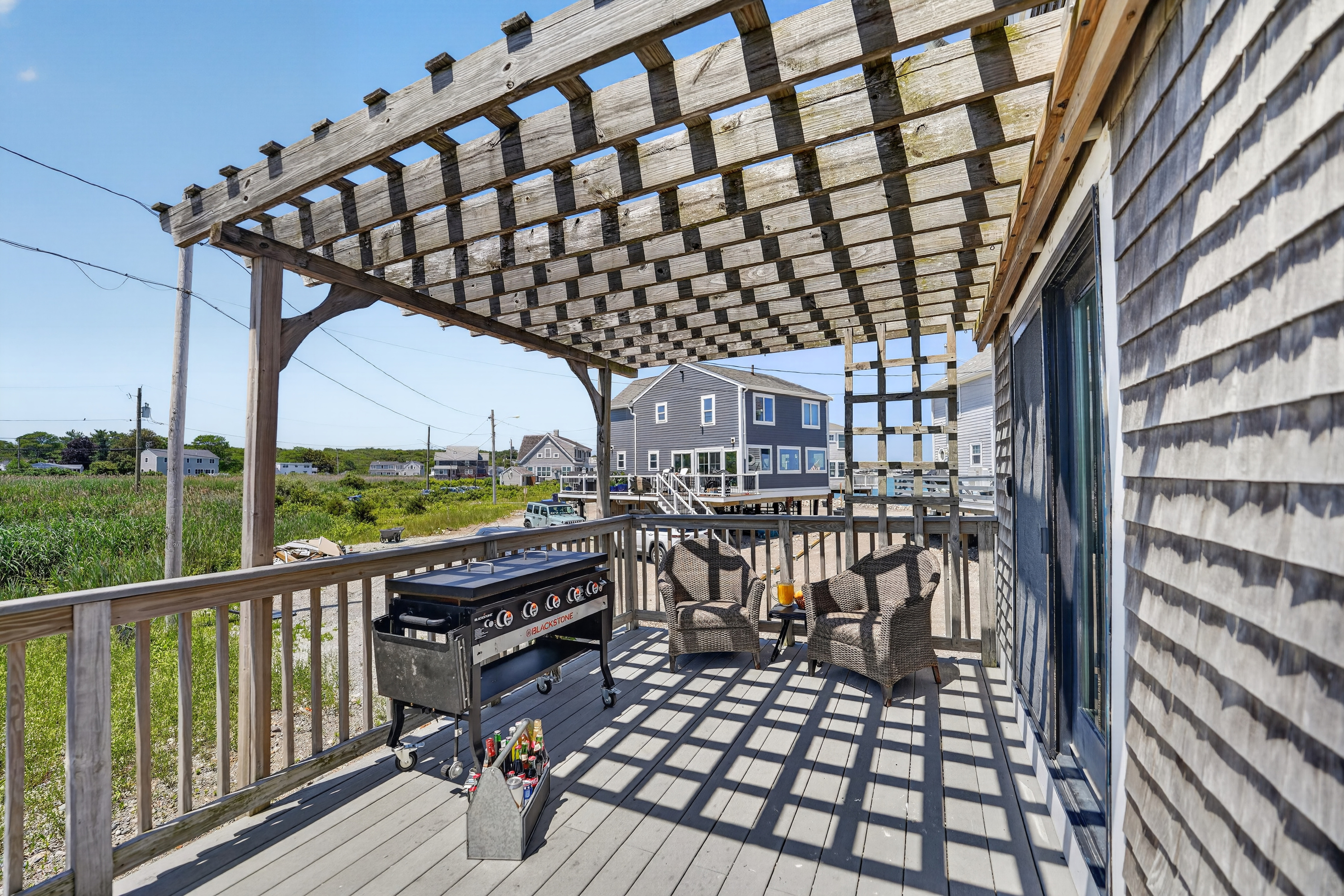 Outdoor dining and grilling area makes it easy to enjoy meals in the fresh coastal air.