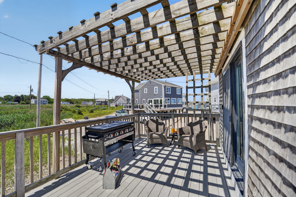 Outdoor dining and grilling area makes it easy to enjoy meals in the fresh coastal air.
