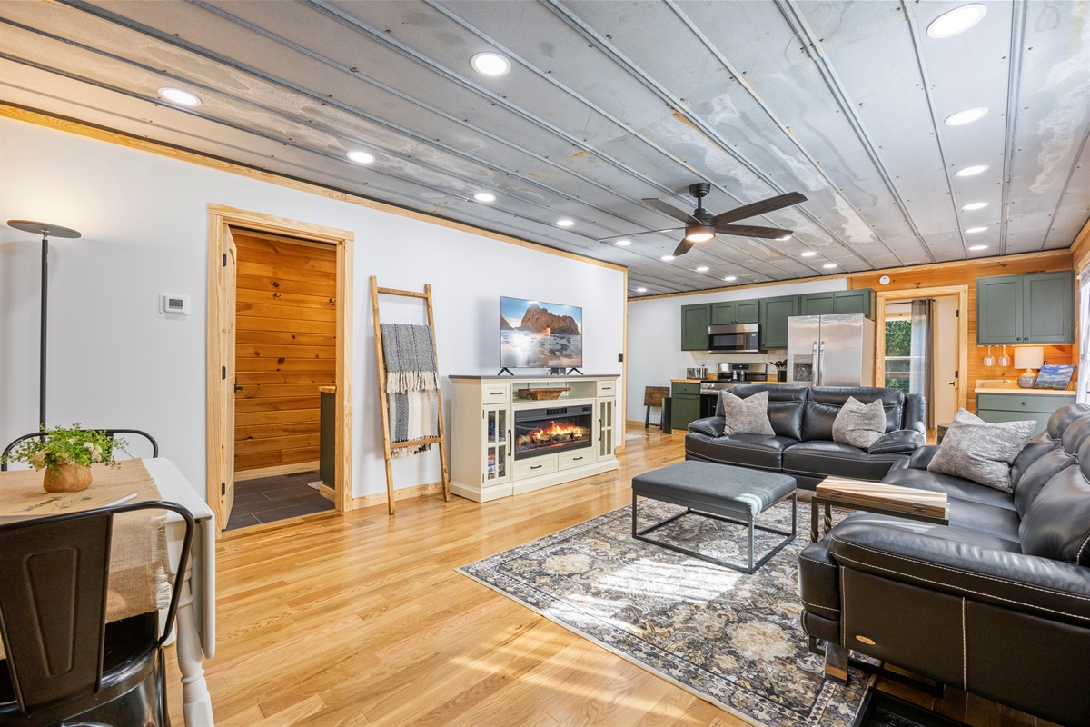 Open-concept living room with fireplace, smart TV, and plenty of seating to relax.