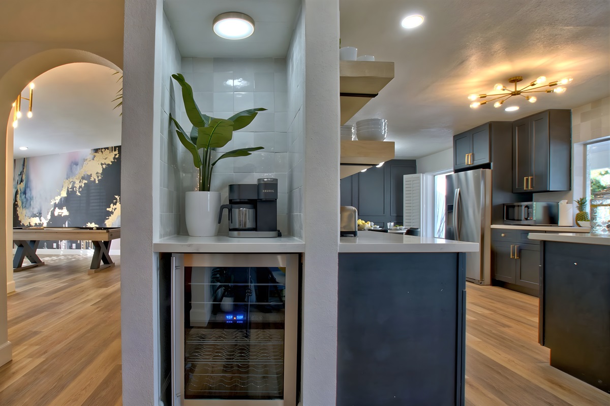 Wine fridge and coffee bar with a Keurig that makes drip coffee or K-Cups. Starter K-Cups are provided.