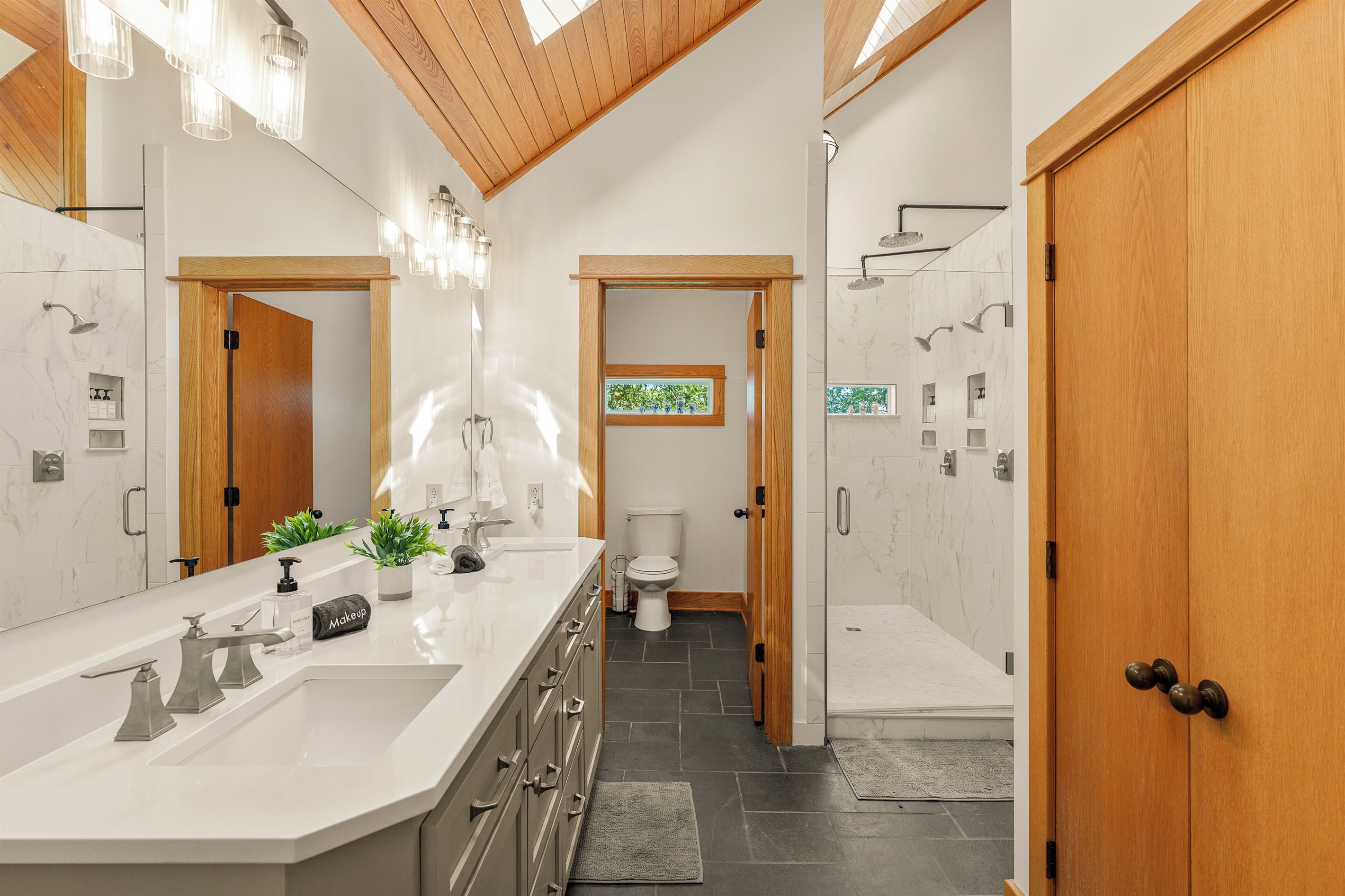 Ensuite bathroom to BR1 with dual vanities and massive shower
