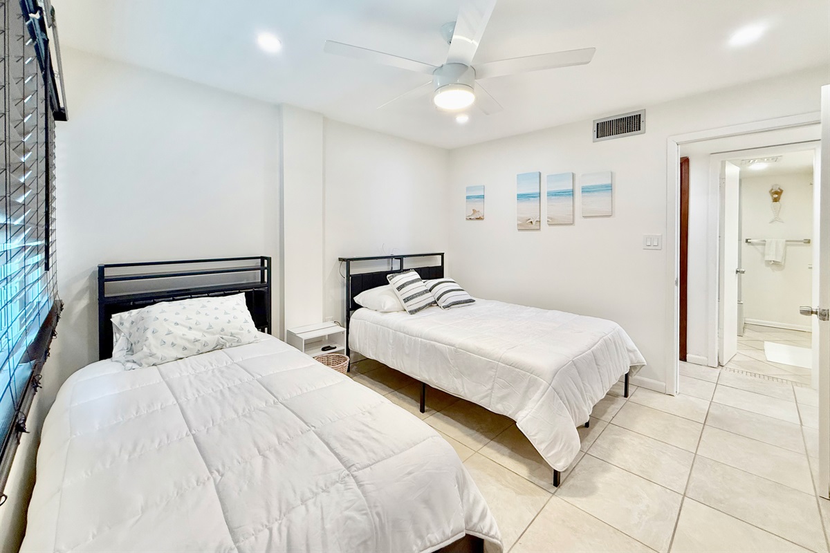 The perfect spot for families or a couple in this guest bedroom with a Queen and twin bed.