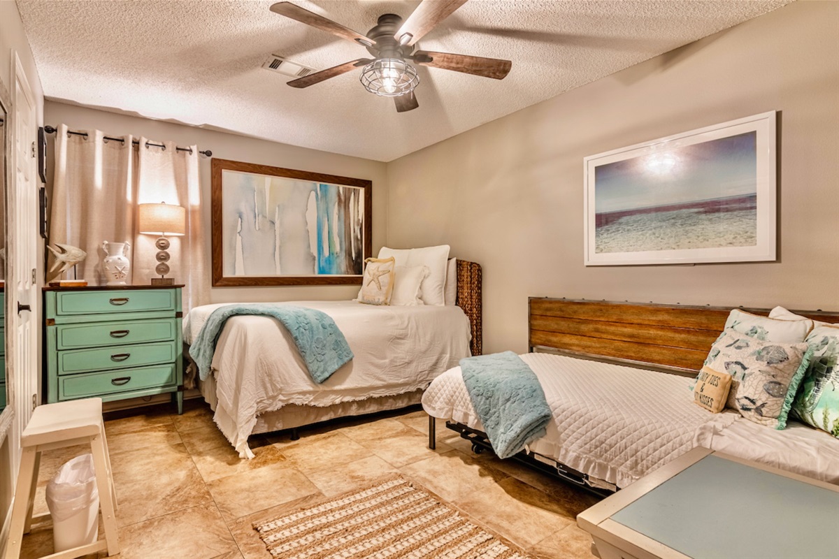 Guest bedroom with ceiling fan, smart TV, and ensuite bathroom