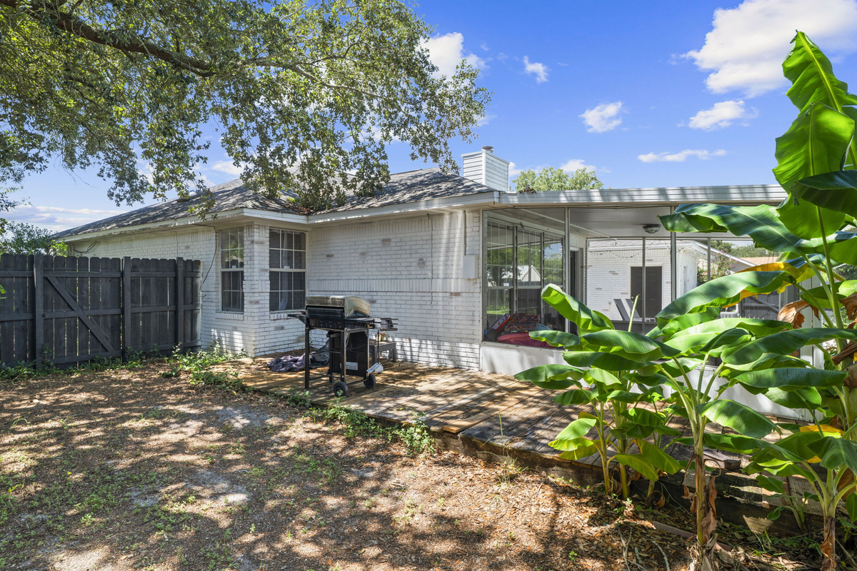 Fire up the propane grill for a cookout on the back patio, shaded by mature oak trees