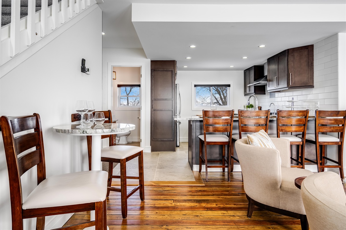 Natural wood table anchors a bright room.