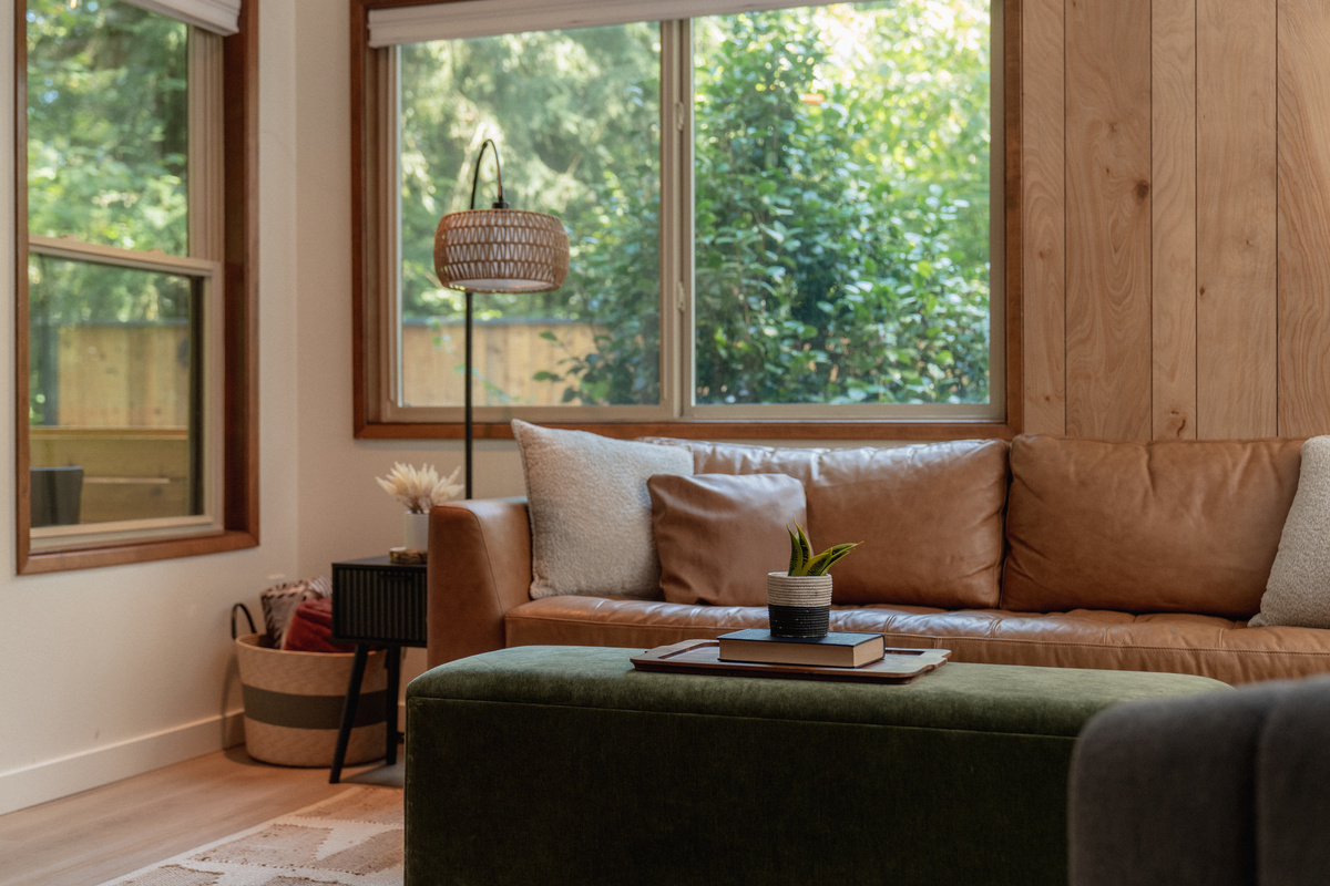Leather, wood, and windows full of green — this corner was made for slow mornings.