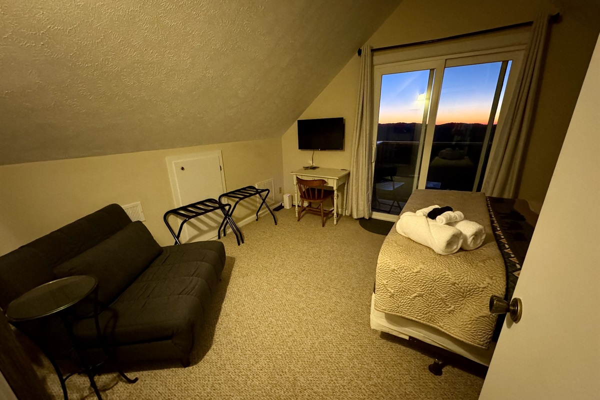 Our Top Floor Queen View Bedroom has a private balcony with sliding door to enjoy the mountain & valley views - the reason you stay in Seven Devils - high above it all! It also has a Desk, Chair, Roku Smart TV, & Twin Futon. Be nice & share that view!
