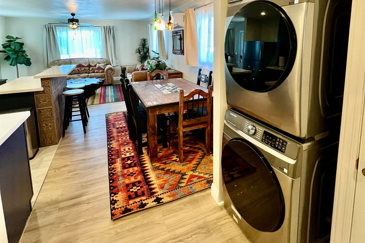 Enjoy the convenience of an in-unit, stacked washer and dryer, located just off the rustic dining area and open-plan living room.