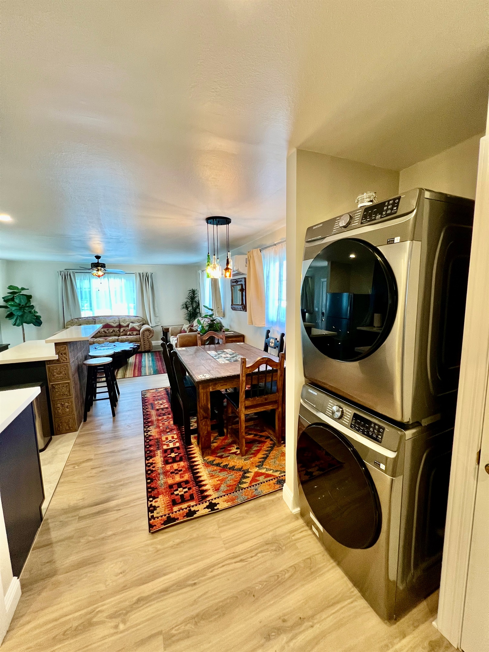 Enjoy the convenience of an in-unit, stacked washer and dryer, located just off the rustic dining area and open-plan living room.