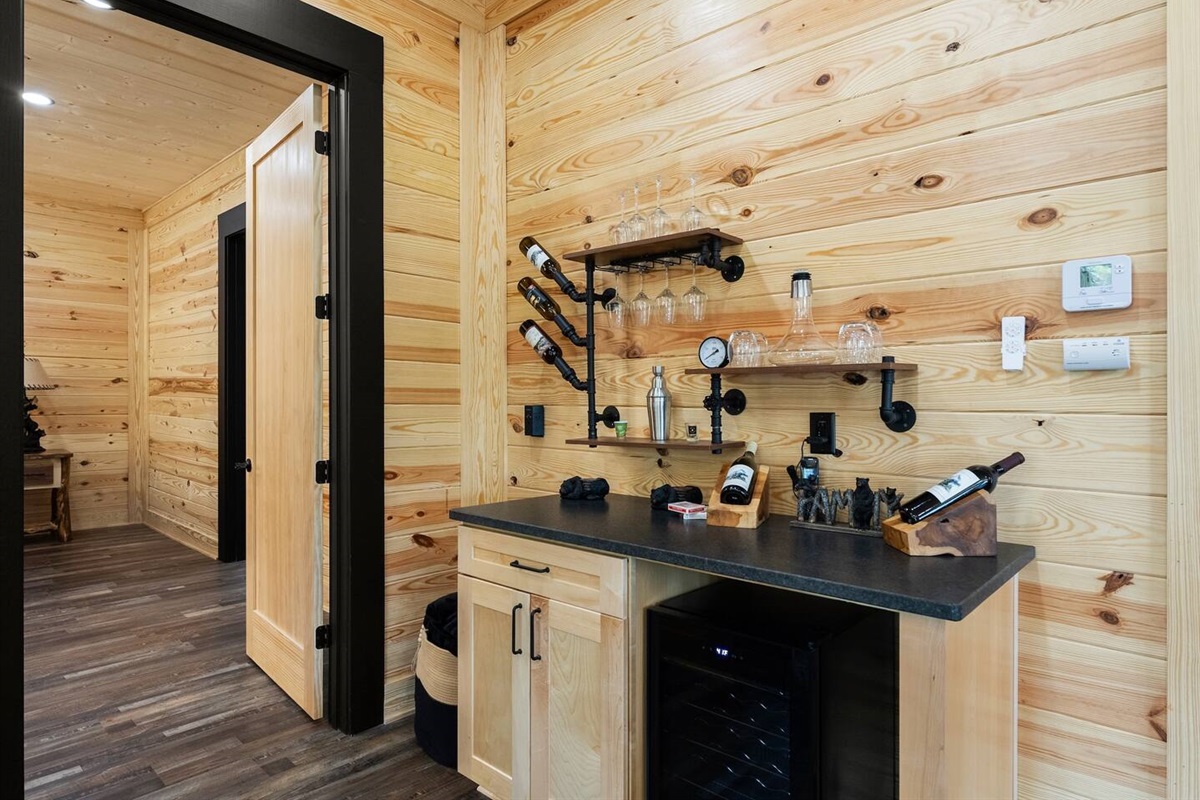 Elevate your evenings with wine and cocktails from the built-in bar—complete with a wine fridge, glassware, and artisan shelving.