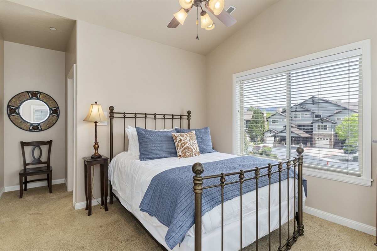 Comfortable bedroom with charming décor, additional sleeping space, and lovely views.