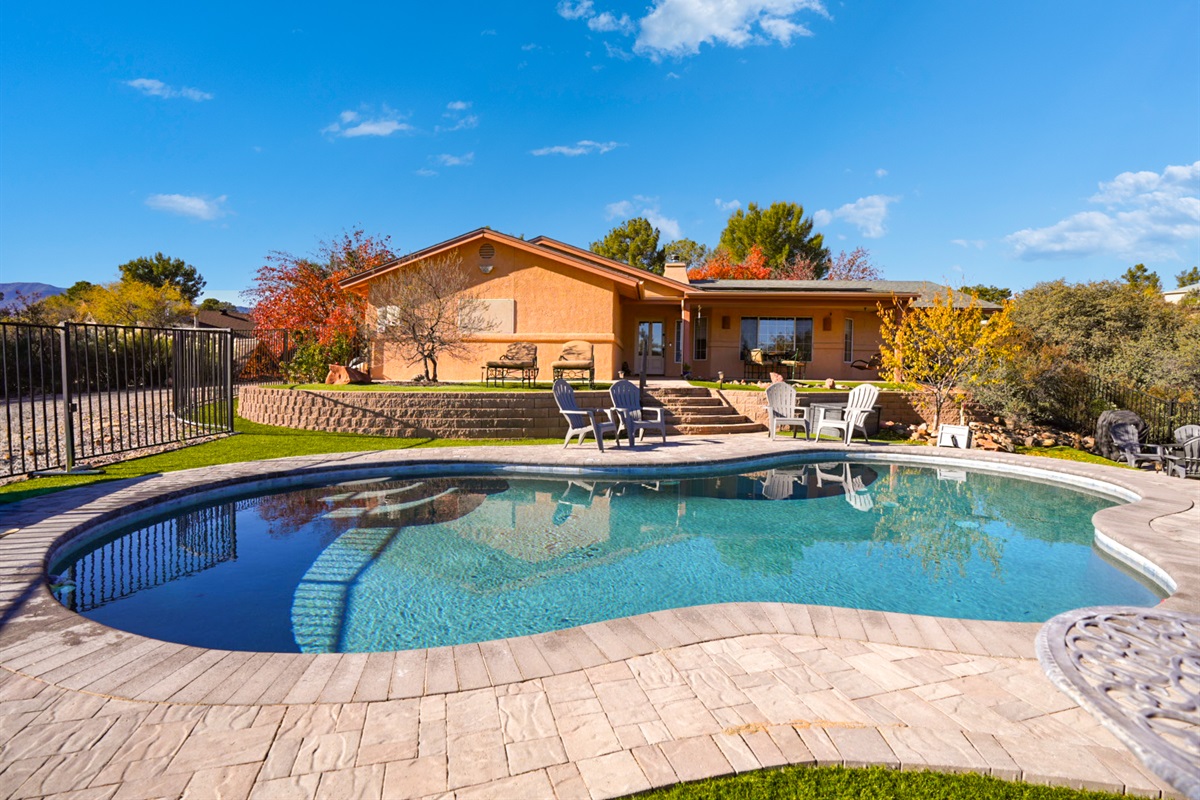 Private oasis with in-ground pool, lounge chairs, fire pit, outdoor dining, and propane BBQ—your own desert retreat.