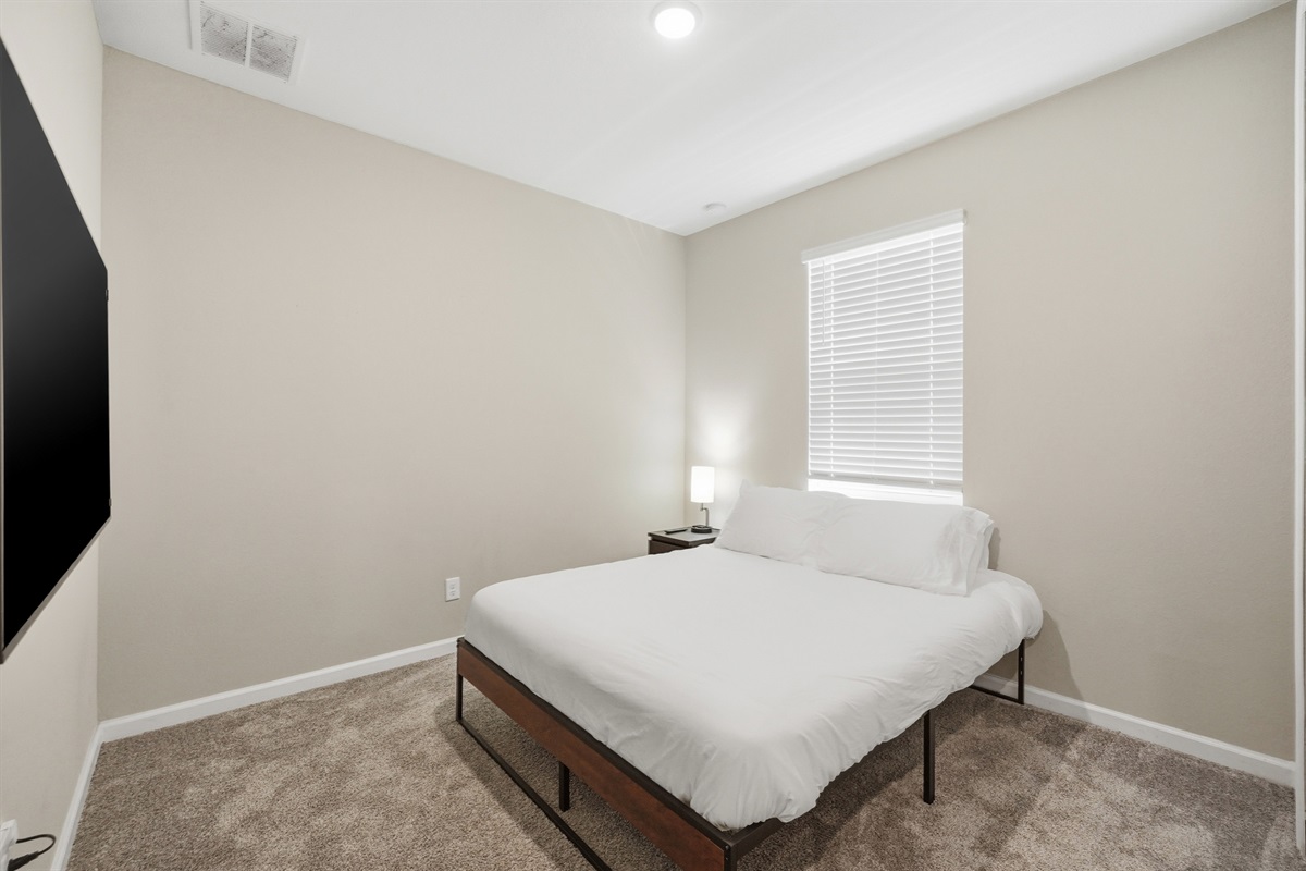 Guest room with queen bed and 55" smart TV