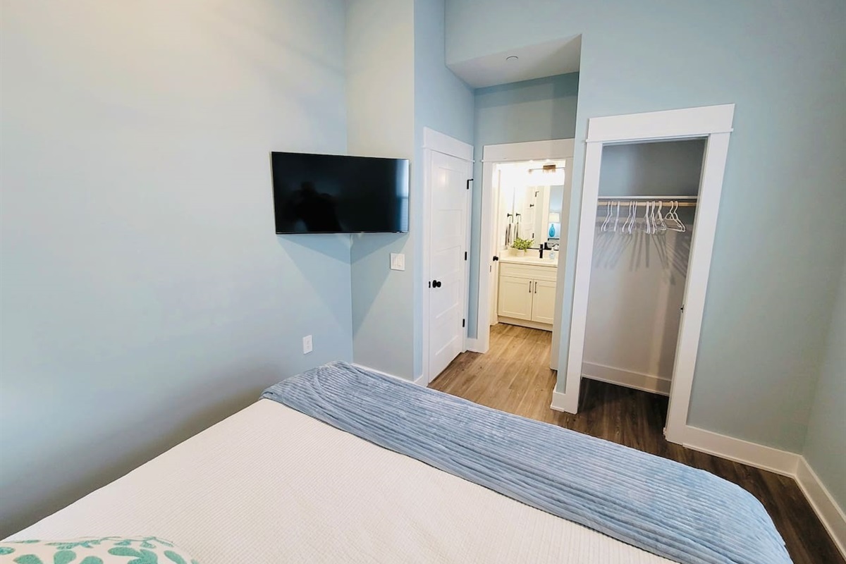 King bedroom has direct access via pocket door to the guest bathroom.   Also has large closet with shelves.