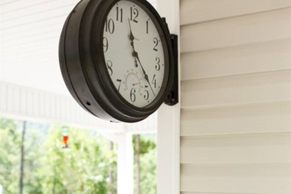 clock on wrap around porch with mountain views at rental