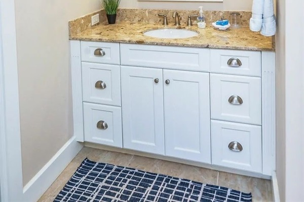 Vanity space and linen storage just outside the main bath.