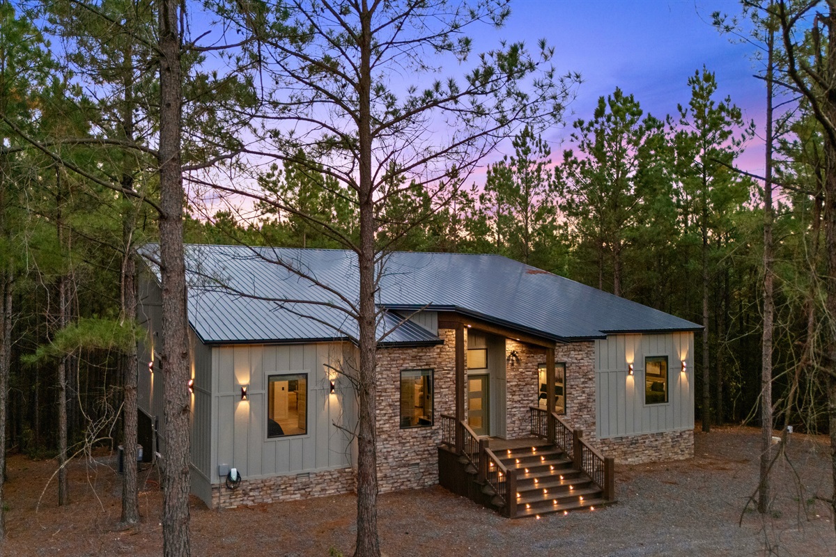 The modern exterior welcomes you with clean lines, warm lighting, and a sense of serenity that sets the tone for your stay.