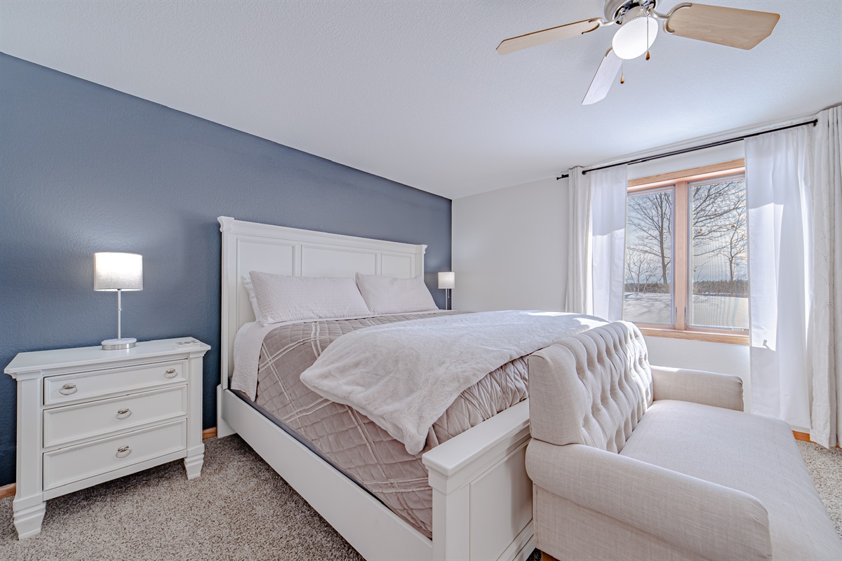 This cozy master bedroom is spacious, has a nice smart TV and beautiful lake views!