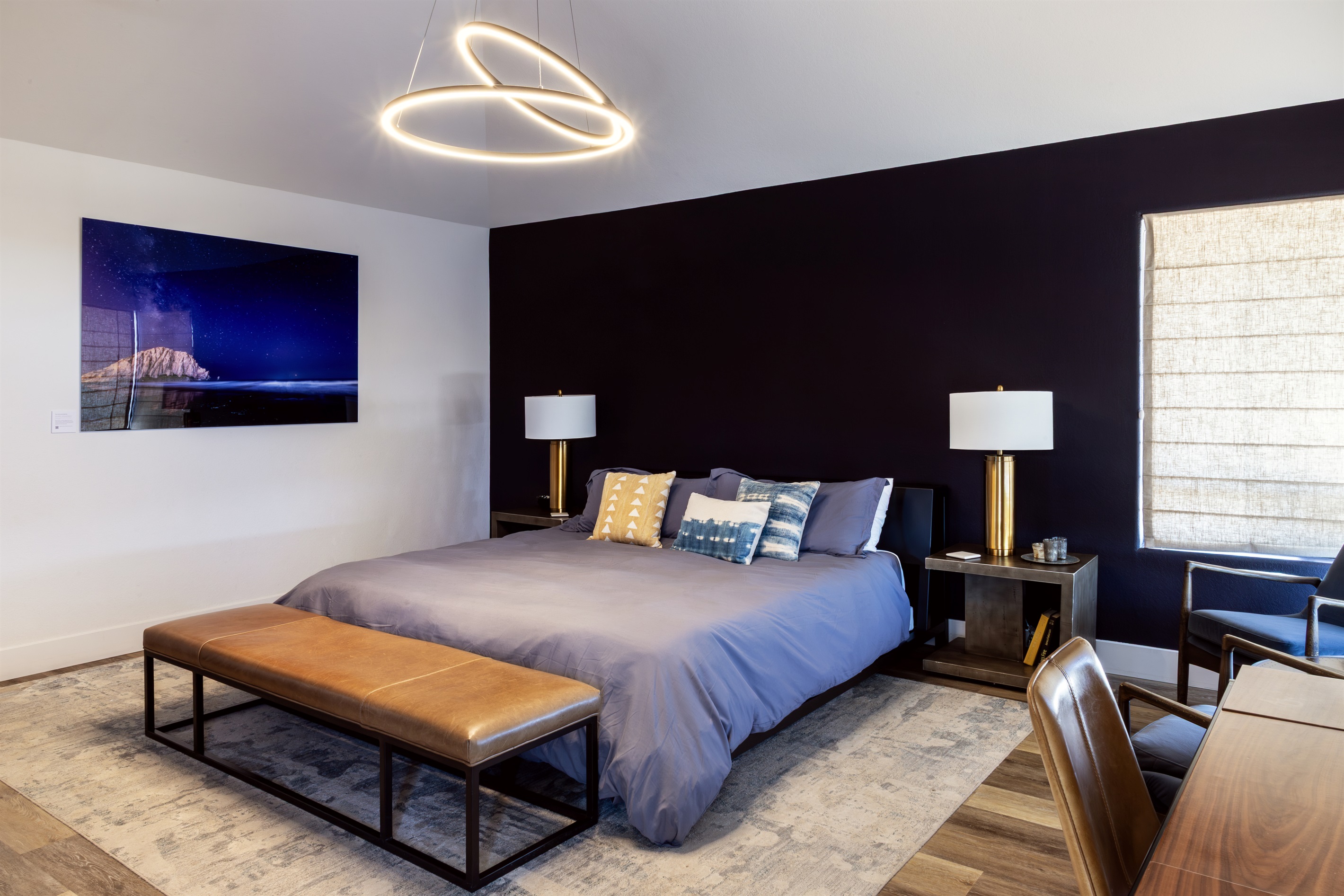 Drama meets luxury in the statement master suite — a bold accent wall, sculptural pendant light, and a king bed dressed for the best sleep of your life.