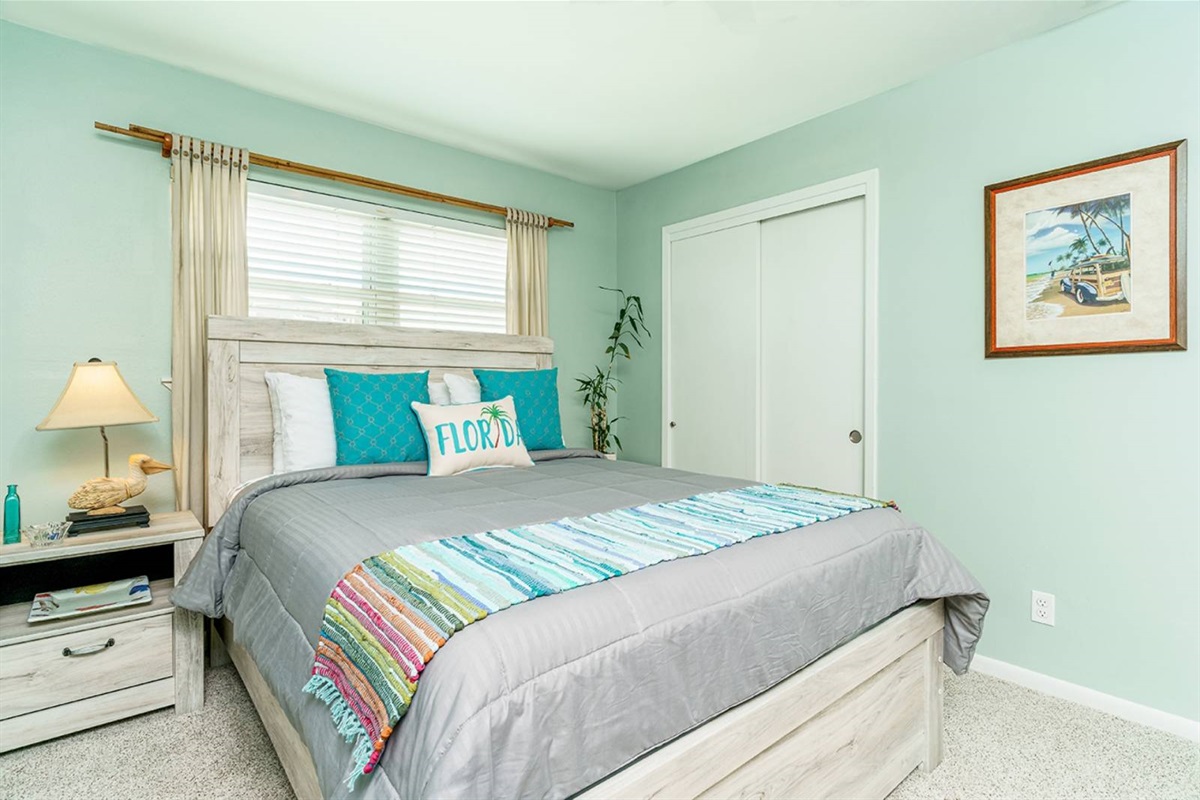 Queen bed with a driftwood-style frame and teal accents. Combined with the king master and queen sleeper, The Perch sleeps 6.