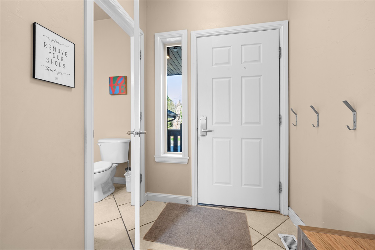 Convenient main-level entry with nearby bathroom access and functional storage space.